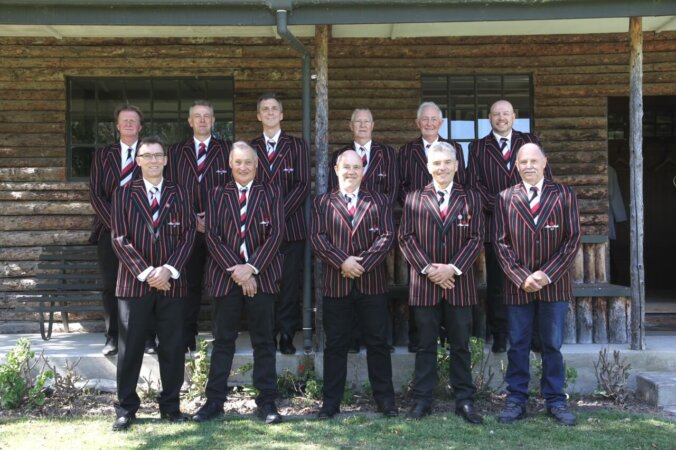 Cricket team in striped blazers