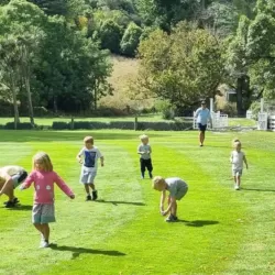 Children running an egg and spoon race on grass